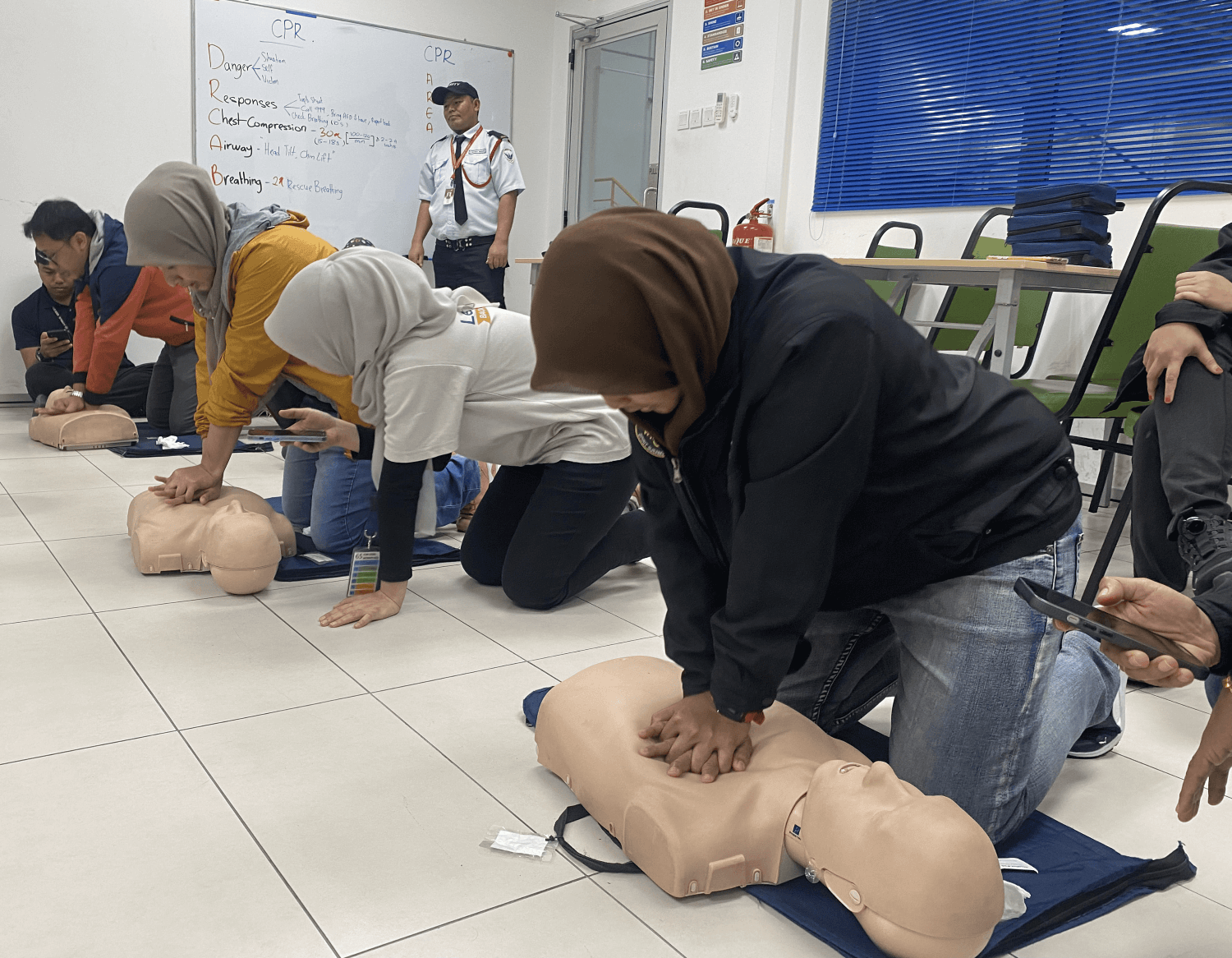 CPR practice during first aid training with ASEC