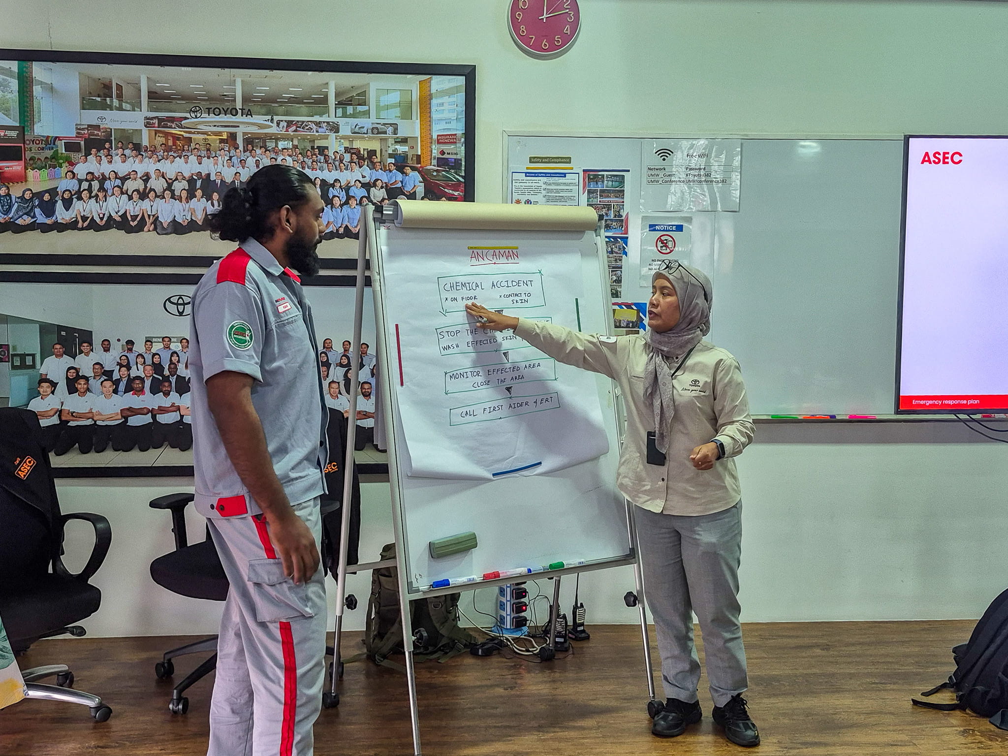 a woman pointing at a whiteboard
