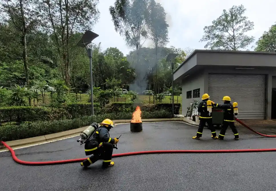 ASEC Firefighting Training participants performing live fire drills and extinguisher simulations under trainer supervision.