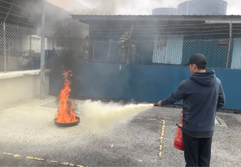 ASEC Firefighting Training participants performing live fire drills and extinguisher simulations under trainer supervision.