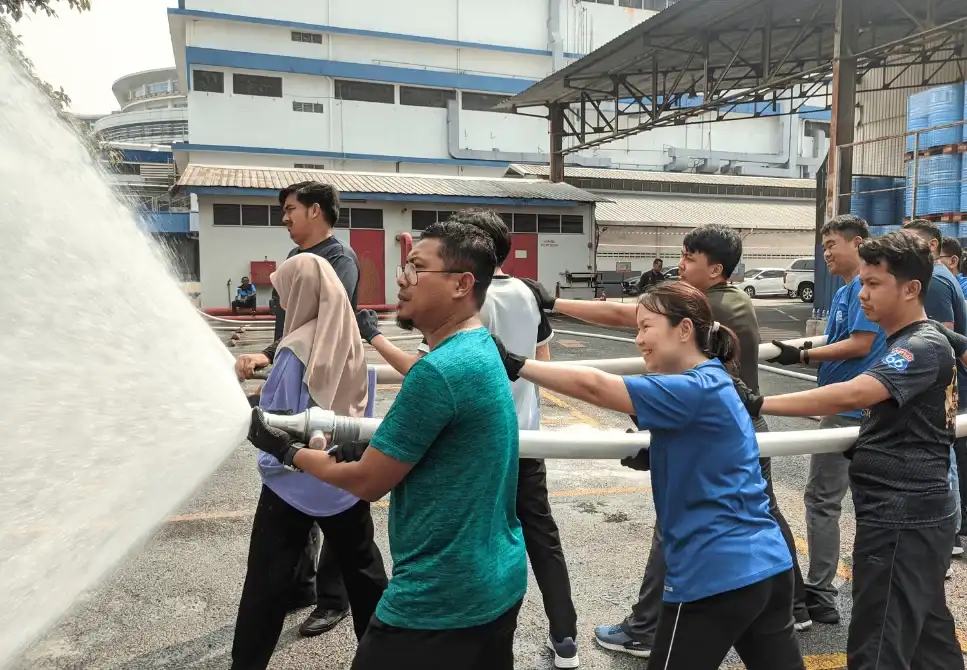 ASEC Firefighting Training participants performing live fire drills and extinguisher simulations under trainer supervision.