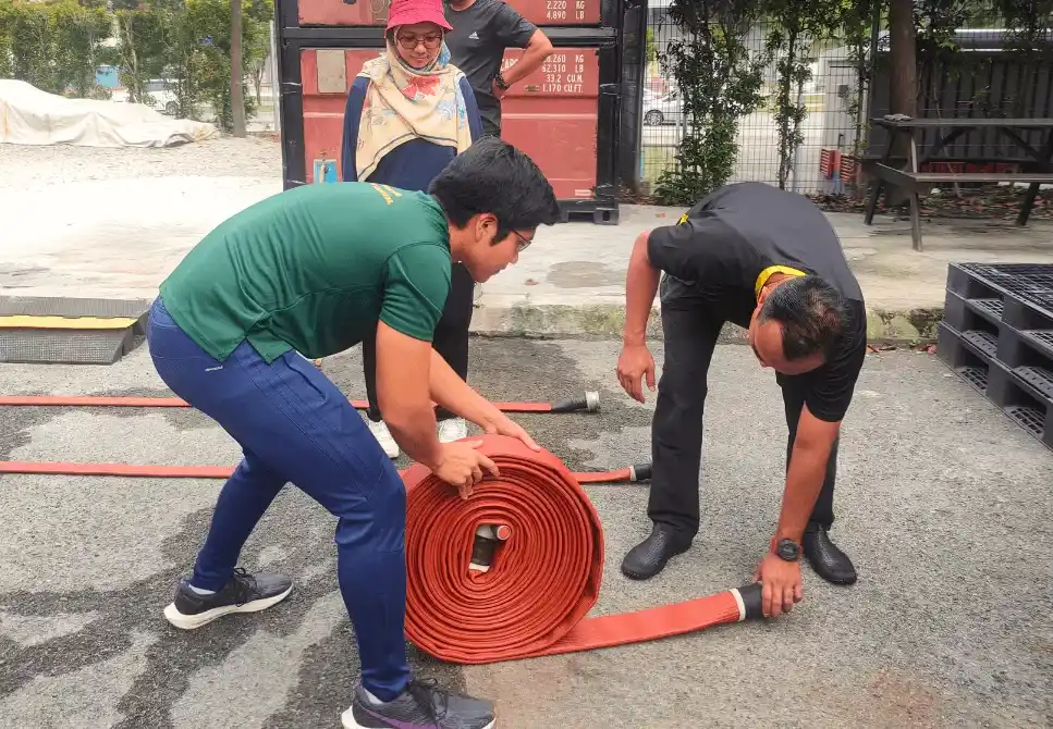 ASEC Firefighting Training participants performing live fire drills and extinguisher simulations under trainer supervision.