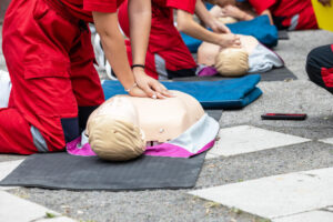 trainer performing CPR training on a manikin