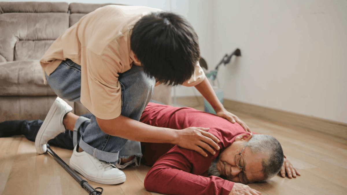 a man inspecting an unconscious old man