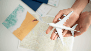 a person holding miniature airplane in their hands