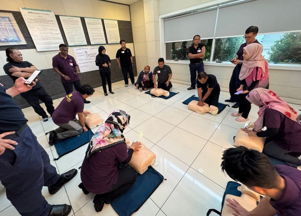 a team performing CPR training on manikins